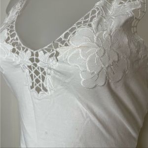 White bodysuit with snap closures and adjustable straps